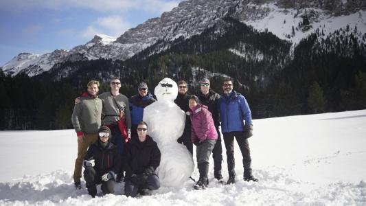 earthwatch volunteers pose with a snowman in the pyrenees