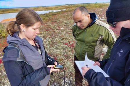 Three Earthwatch participants recording environmental data.